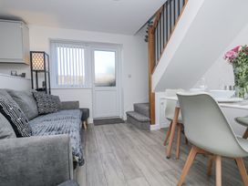 A living room with a sofa and dining area at Cosy Retreat in Pool
