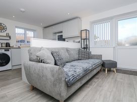 A living room with a sofa and lamp at Cosy Retreat in Pool