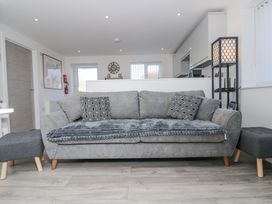 A living room with a sofa and coffee table at Cosy Retreat in Pool
