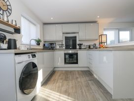 A kitchen with appliances and utensils at Cosy Retreat Pool