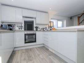 A kitchen with cabinets and appliances at Cosy Retreat in Pool
