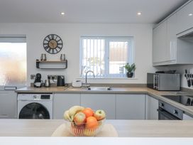 A kitchen with a fruit bowl and washing machine at Cosy Retreat in Pool