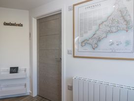 A hallway with a door and a map on the wall at Cosy Retreat in Pool