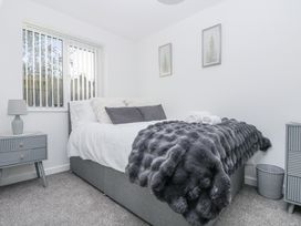 A bedroom with a bed and bedside table at Cosy Retreat in Pool