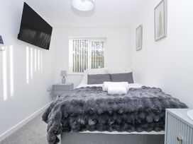 A bedroom with a bed and bedside table at Cosy Retreat in Pool