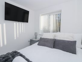 A bedroom with a bed and television at Cosy Retreat in Pool