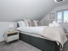 A bedroom with a bed and nightstand at Cosy Retreat in Pool