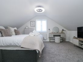 A bedroom with a bed and dresser at Cosy Retreat in Pool