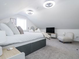 A bedroom with a bed and television at Cosy Retreat in Pool