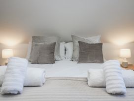 A bed with pillows and towels at Cosy Retreat in Pool