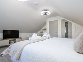 A bedroom with a bed and television at Cosy Retreat in Pool