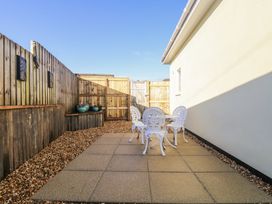 A patio area with a table and chairs at Cosy Retreat in Pool