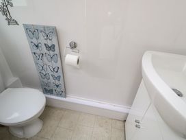 A bathroom with a toilet and sink at Sea Whispers in Marazion