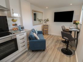 A kitchen with a sofa and dining area at Sea Whispers in Marazion
