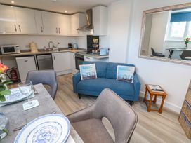 A kitchen with a sofa and dining area at Sea Whispers in Marazion