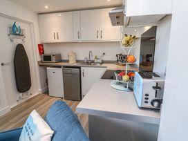 A kitchen featuring a sink, microwave, and refrigerator at Sea Whispers in Marazion