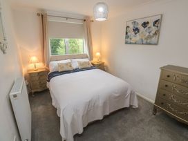 A bedroom with a bed and bedside tables at Sea Whispers in Marazion