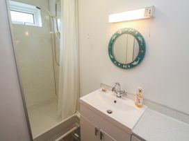 A bathroom with a shower and sink at Sea Whispers in Marazion