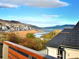 A view of the beach and sea with houses in the background at proposed 3 bed apartment in Lyme Regis