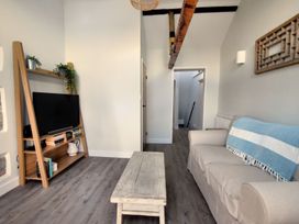 A living room with a television and a coffee table at proposed 3 bed apartment in Lyme Regis