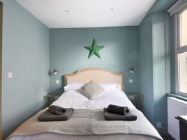 A bedroom with a bed and towels at proposed 3 bed apartment Lyme Regis