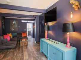 A living room with a sofa and lamps at Avocet in Lyme Regis