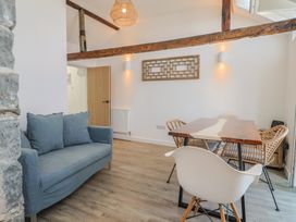 A living room with a couch and dining table at Avocet in Lyme Regis
