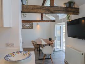 A dining room with a table and chairs at Avocet in Lyme Regis