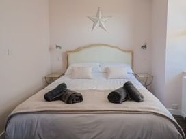A bedroom with a bed and towels at Avocet in Lyme Regis