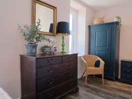 A bedroom with a chest of drawers and a wardrobe at Avocet in Lyme Regis