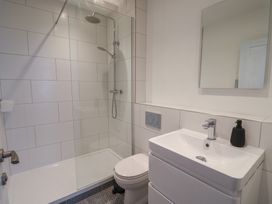 A bathroom with a shower, toilet, and sink at Avocet in Lyme Regis