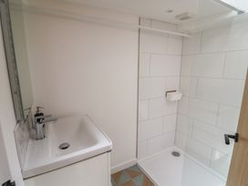 A bathroom with a sink and shower at Avocet in Lyme Regis