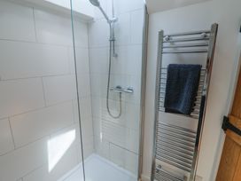 A shower with a towel rail and towel at Avocet in Lyme Regis
