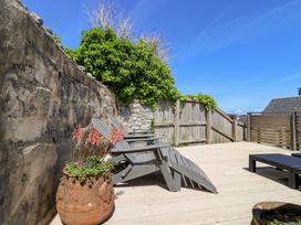 A deck area with chairs and plants at Avocet in Lyme Regis