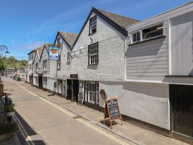 A street view with buildings and a menu board at Avocet Lyme Regis