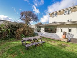 A garden with a picnic table and tree at 3 Brook Cottages Hope Cove