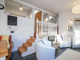 A living room with a dining table and chairs at 3 Brook Cottages in Hope Cove