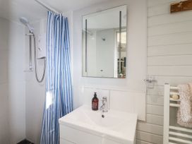 A bathroom with shower and sink at 3 Brook Cottages Hope Cove