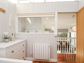 A room with a chest of drawers and a door at 3 Brook Cottages in Hope Cove