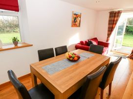 A dining room with a table and chairs at The Old Barn in Pwllheli