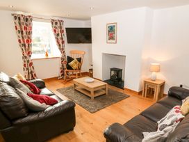 A living room with a coffee table and sofa at The Old Barn in Pwllheli