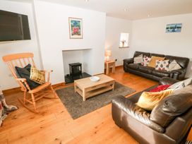 A living room with a sofa and coffee table at The Old Barn in Pwllheli