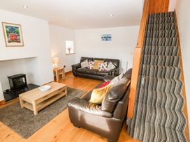 A living room with couches and a coffee table at The Old Barn in Pwllheli