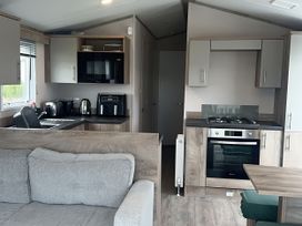 A kitchen with appliances including a microwave and stove at 30 Wells Close Berwick-upon-Tweed