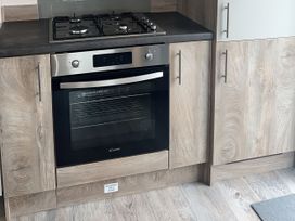 A kitchen with an oven and gas stove at 30 Wells Close Berwick-upon-Tweed