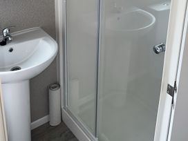 A bathroom with a sink and a shower at 30 Wells Close Berwick-upon-Tweed