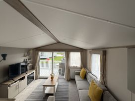 A living room with a television and sofa at 30 Wells Close in Haggerston