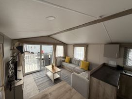 A living room with a sofa and coffee table at 30 Wells Close Haggerston