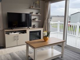 A living room with a television and coffee table at 30 Wells Close in Haggerston