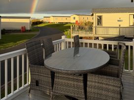 An outdoor dining area with a table and chairs at 30 Wells Close Haggerston